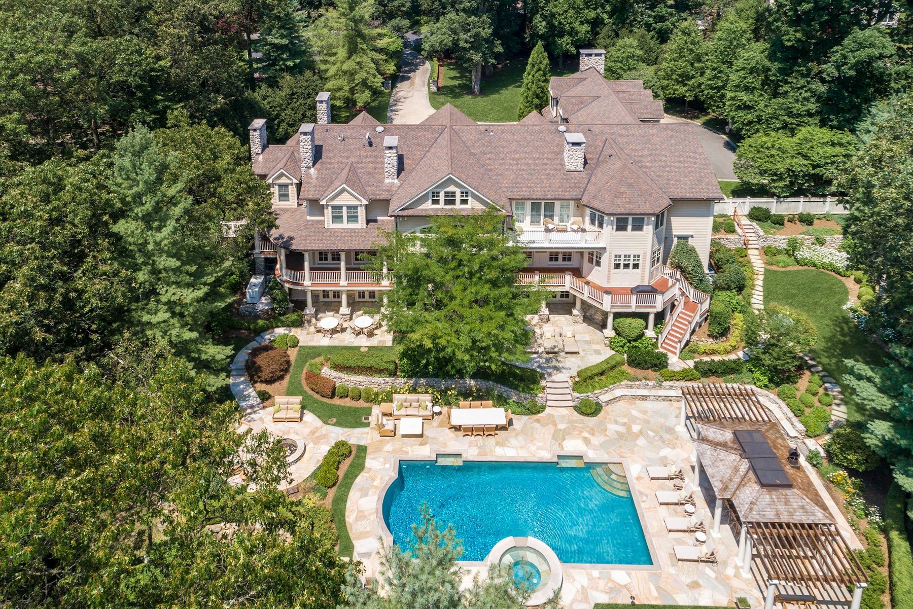 Aerial view of a luxury Bergen County home, pool and landscaped grounds